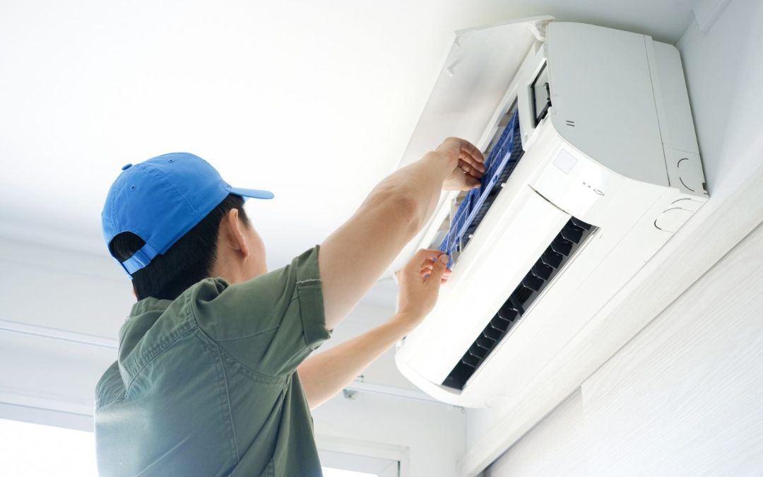 Air conditioning technician maintaining an indoor mini split system in Queen Creek, AZ