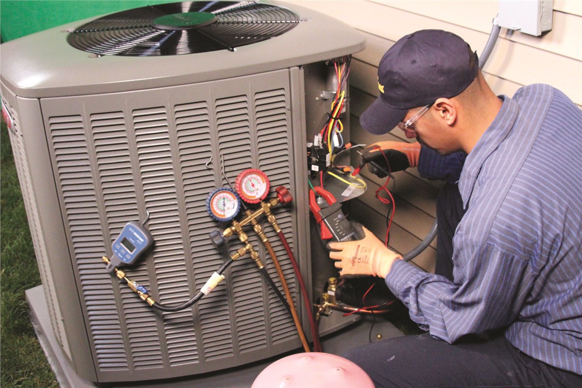 HVAC technician testing an outdoor air conditioning unit in Queen Creek